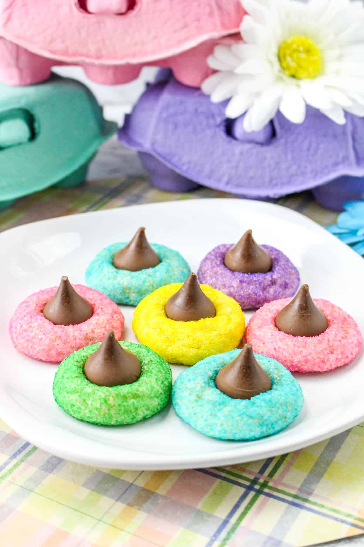 Colorful Easter Blossom Cookies with Hershey Kisses on white plate.