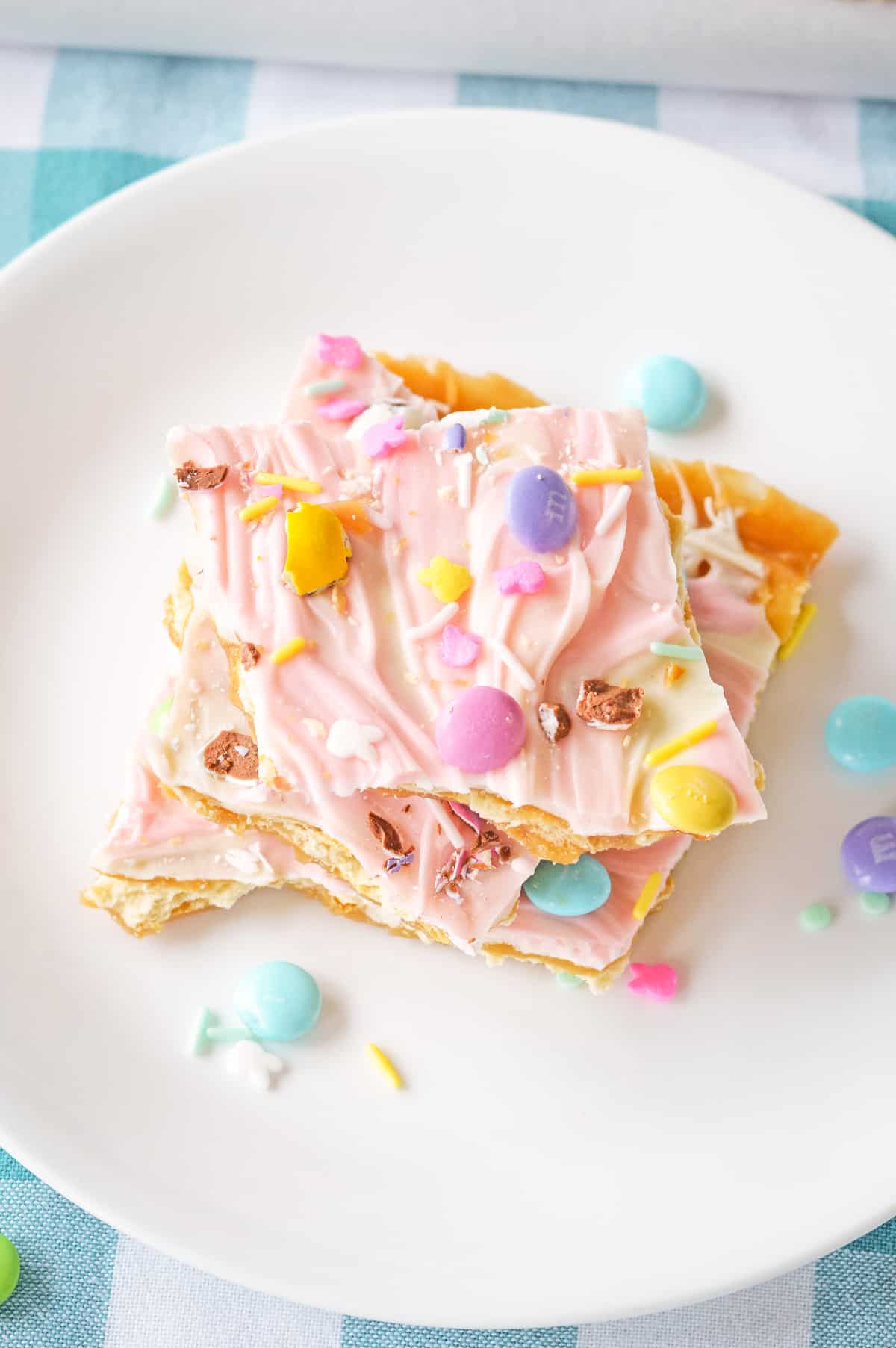 Easter crack candy made with saltines, white chocolate, pink food coloring, and easter candies.