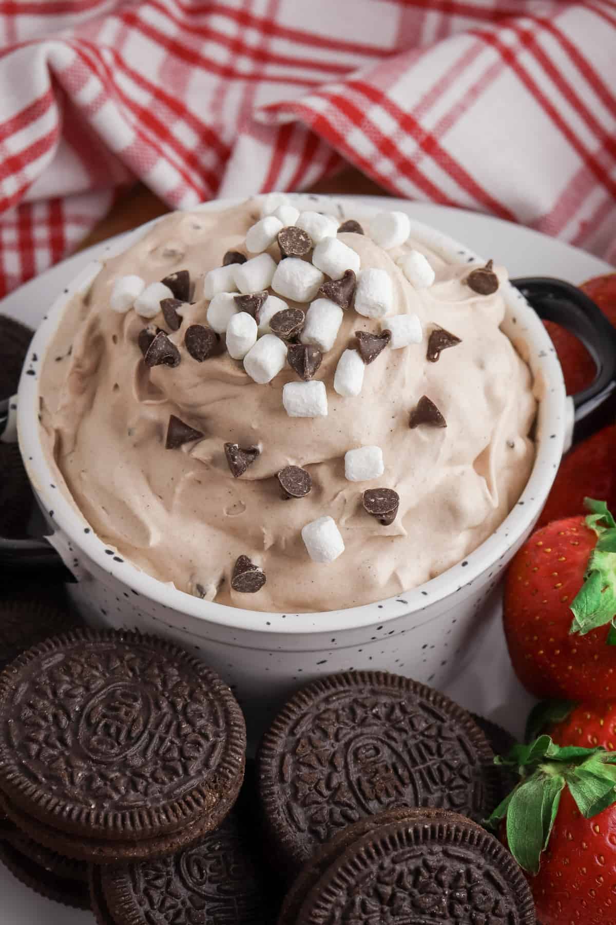 Hot Chocolate Dip topped with chocolate chips and mini marshmallows and served with OREO cookies and strawberries.