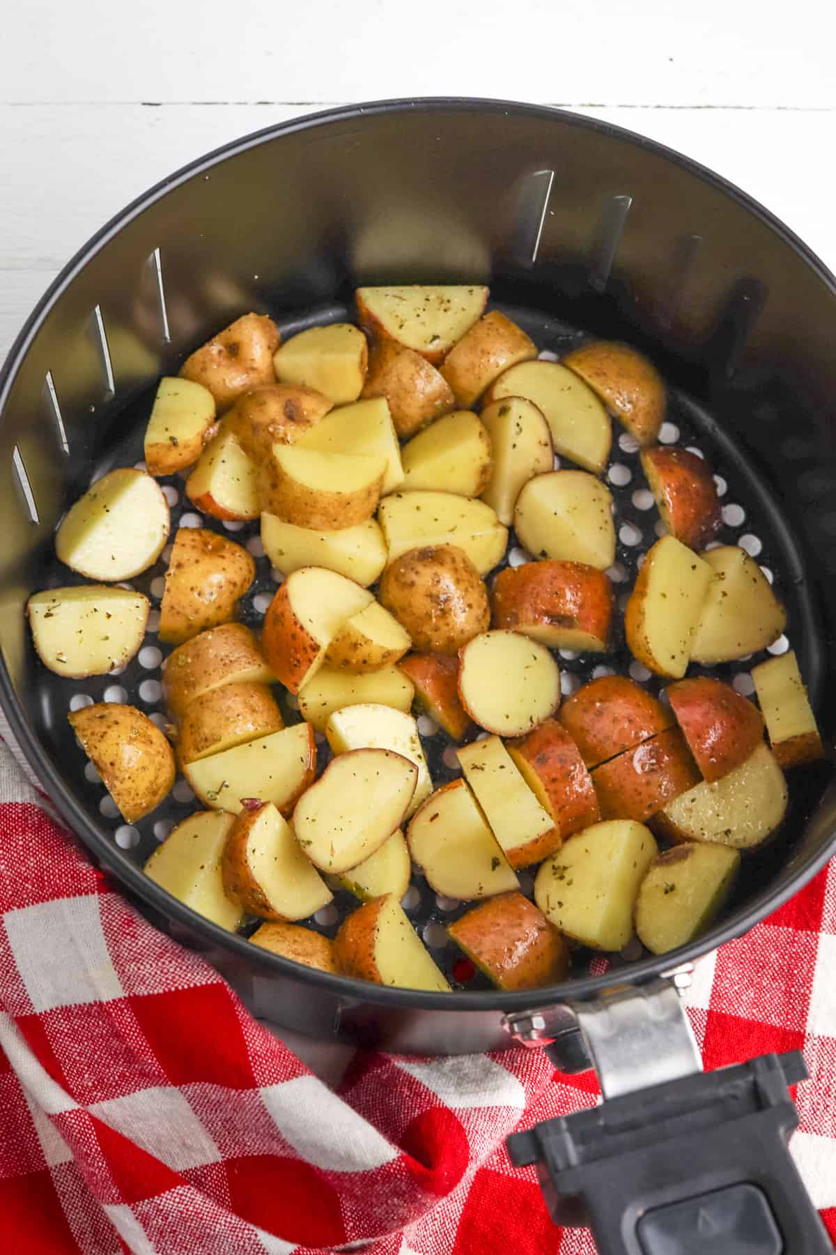 Uncooked potatoes in air fryer.