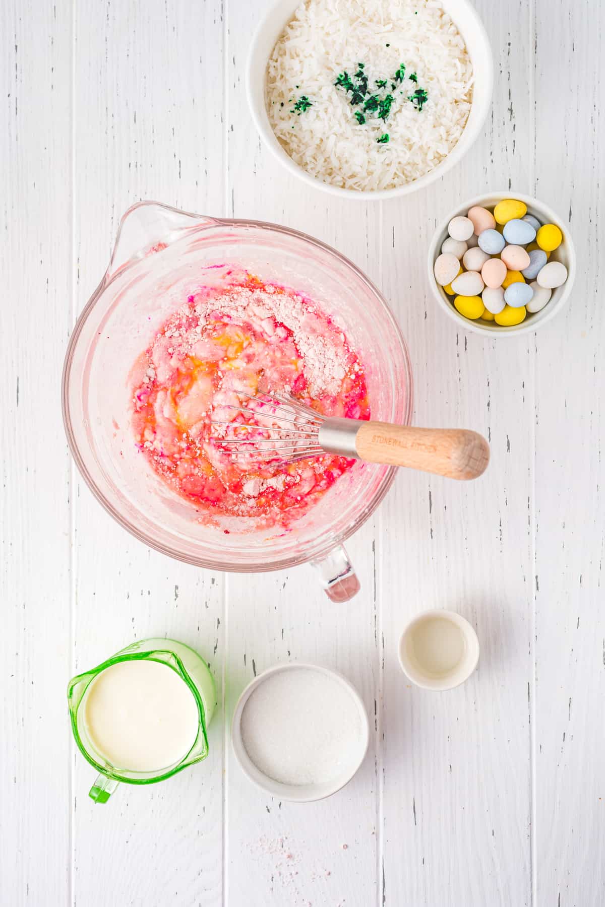 Mixing strawberry cake batter in large glass mixing bowl.