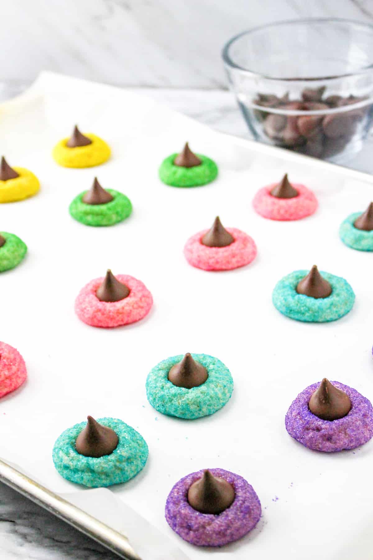 Easy easter cookies with Hershey Kisses on lined baking sheet.
