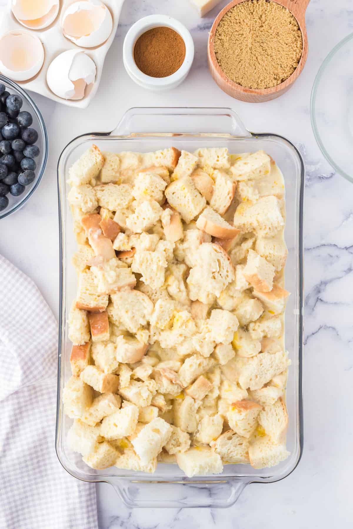 Casserole dish filled with cubed bread.