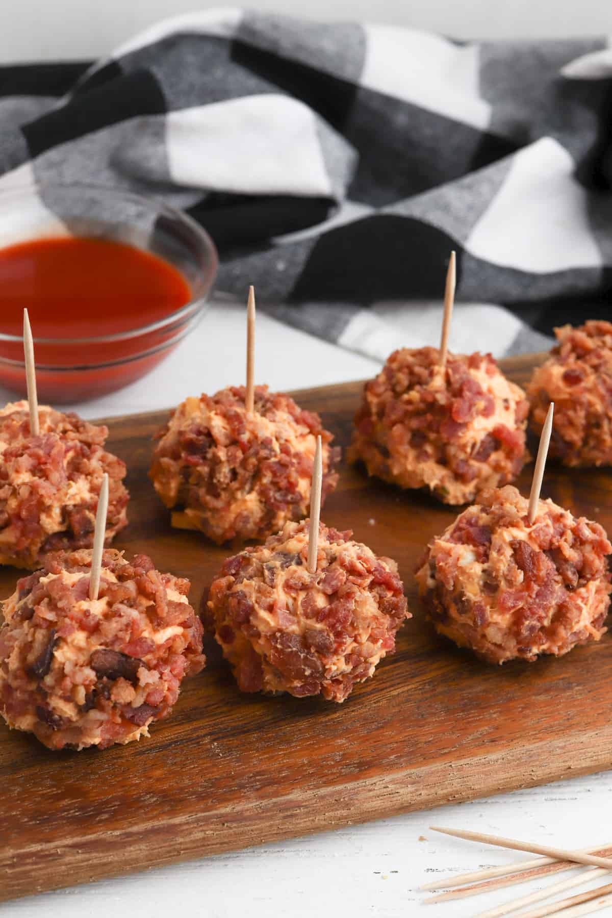 Buffalo chicken cheese balls with bacon on the outside and tooth picks sticking out on top. 