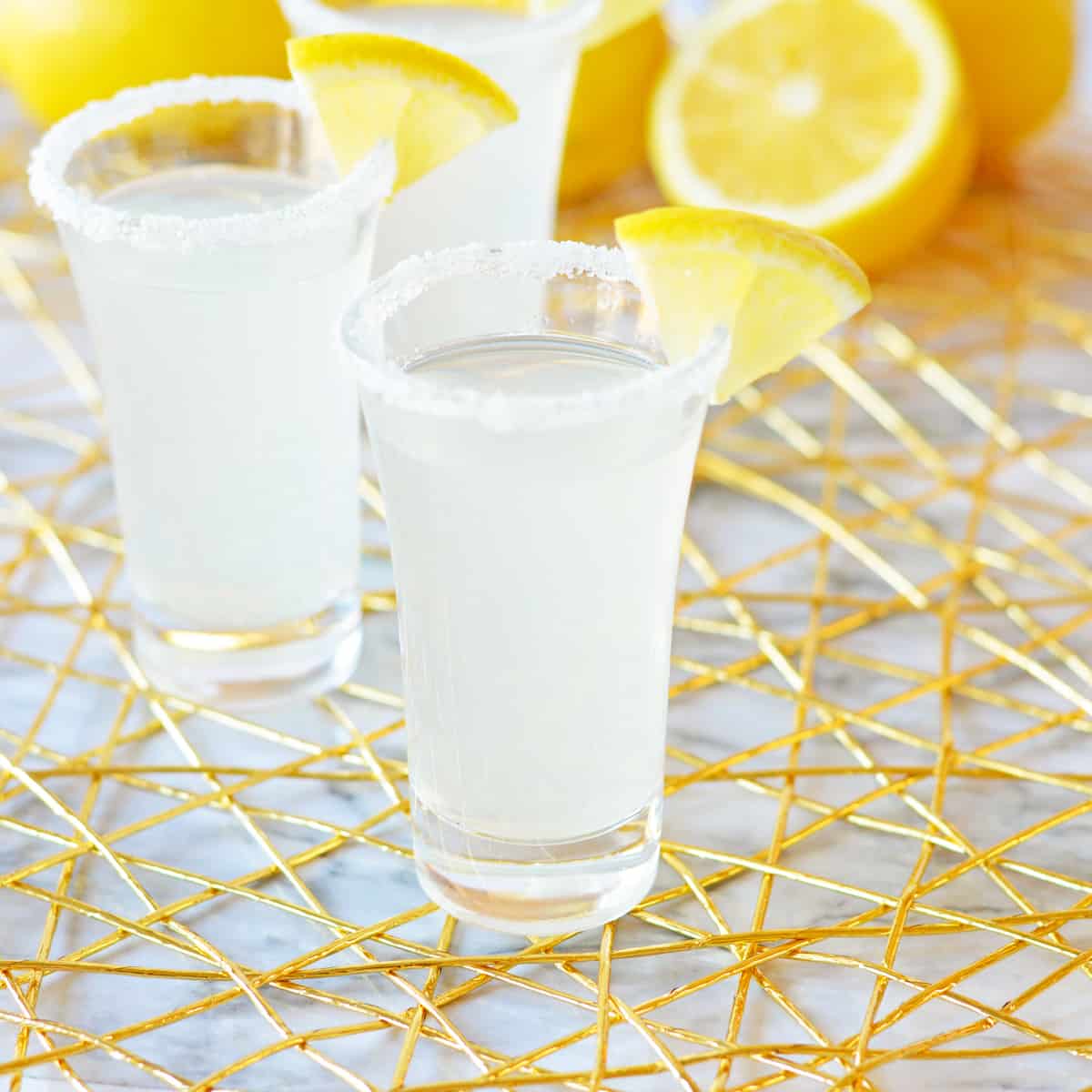 Lemon drop shot with rimmed glass and lemon garnish.