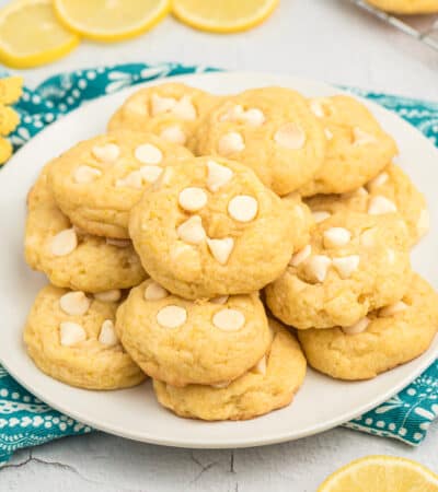 Lemon pudding cookies with white chocolate chips on plate.