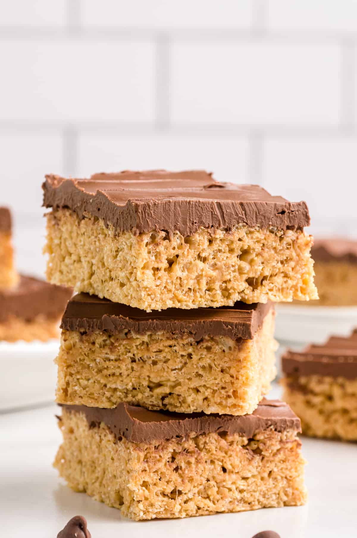 Three peanut butter cereal bars stacked off center.