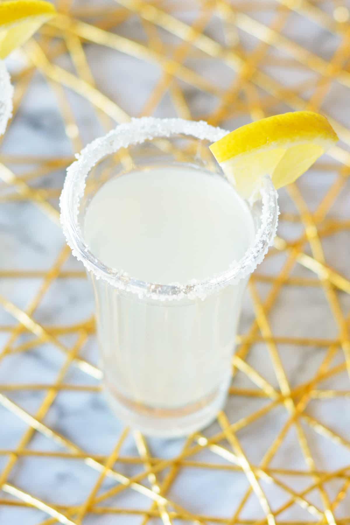 Lemon Drop Shot in 2 ounce shot glass with lemon garnish.