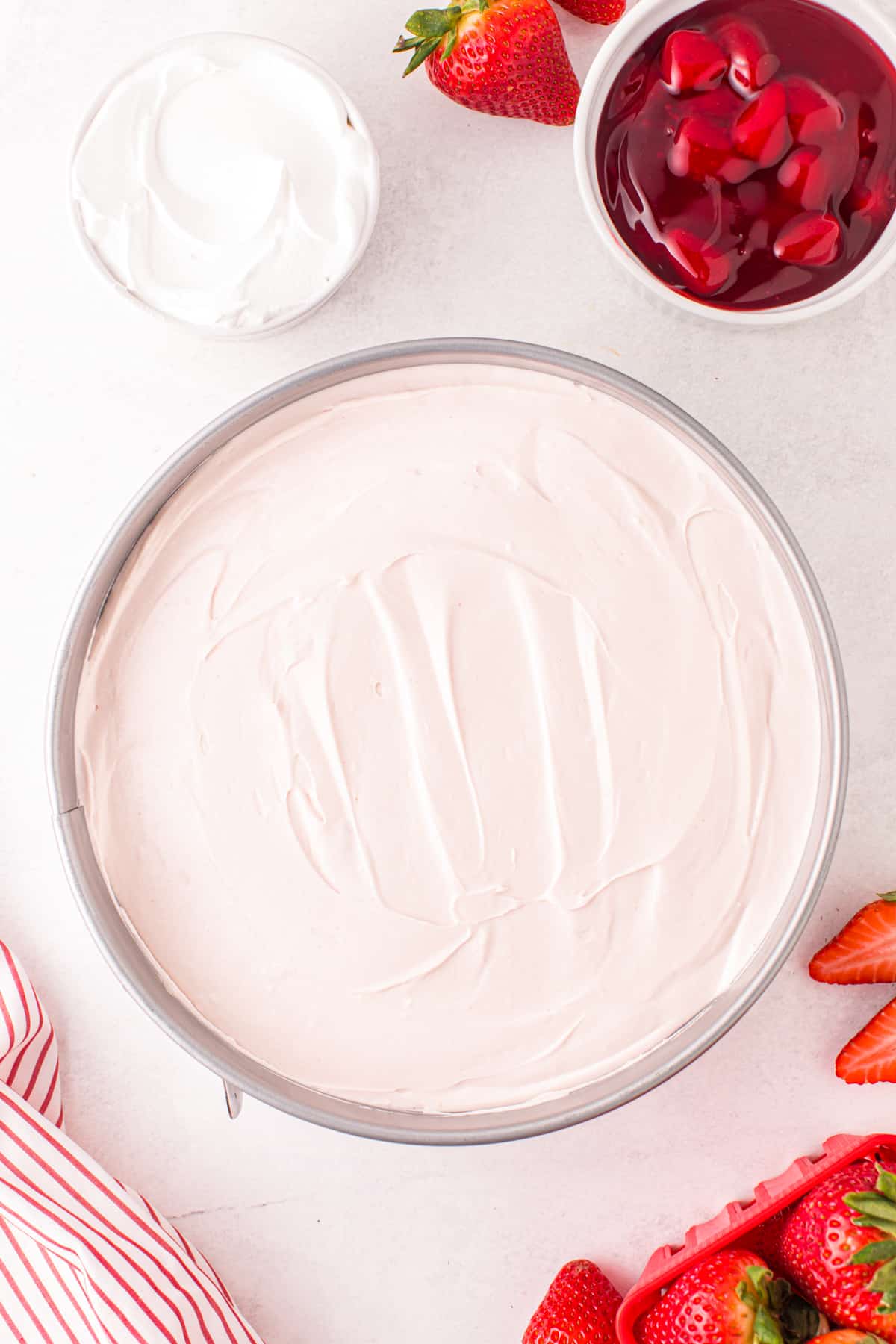 Strawberry no-bake cheesecake in springform pan.