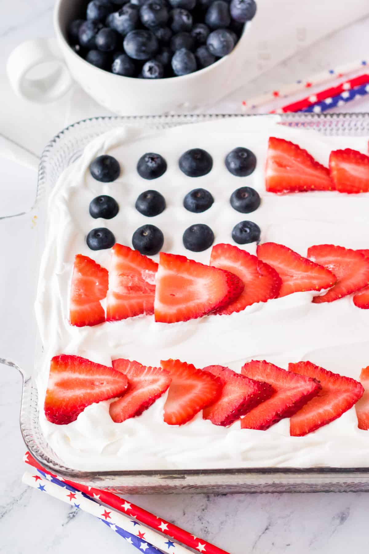 American flag cake made with blueberries and sliced strawberries. 