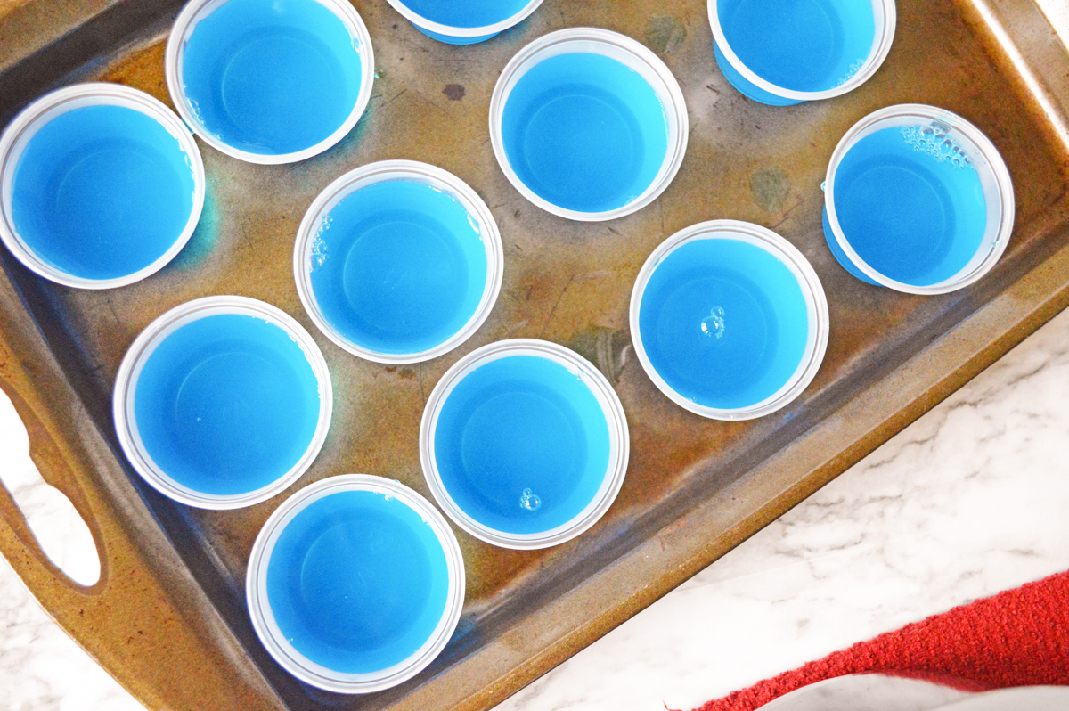 Baking sheet filled with blue jello shots.