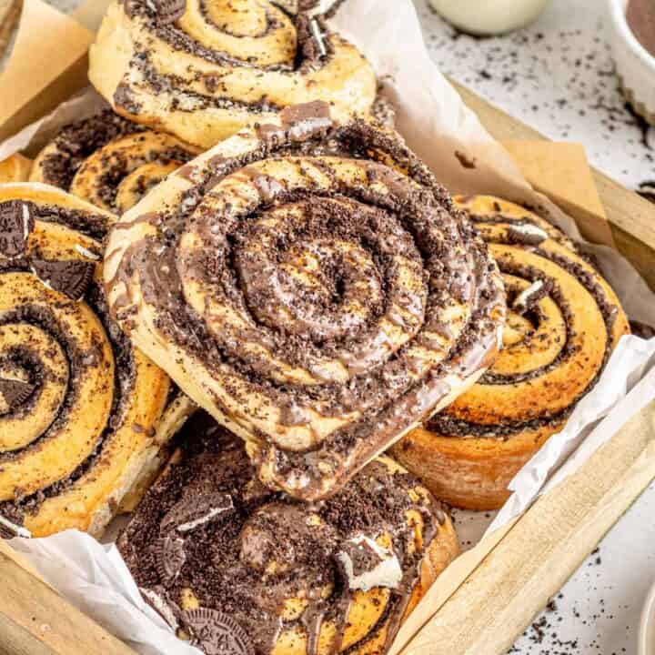 Cookies and cream cinnamon rolls in lined pastry box.
