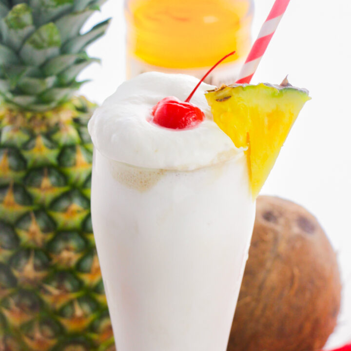 Frozen pina colada with whipped cream, pineapple, and cherry.