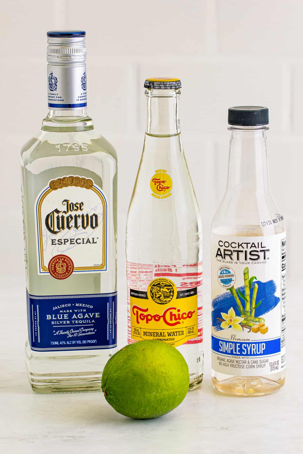 Ingredients for Ranch Water Cocktail: Tequila blanco, Topo Chico, simple syrup, and lime.