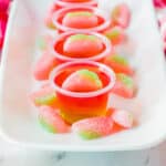 Watermelon vodka jello shots topped with sour gummy candies.