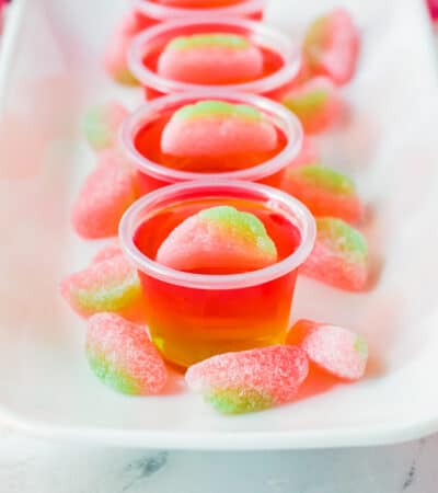 Watermelon vodka jello shots topped with sour gummy candies.