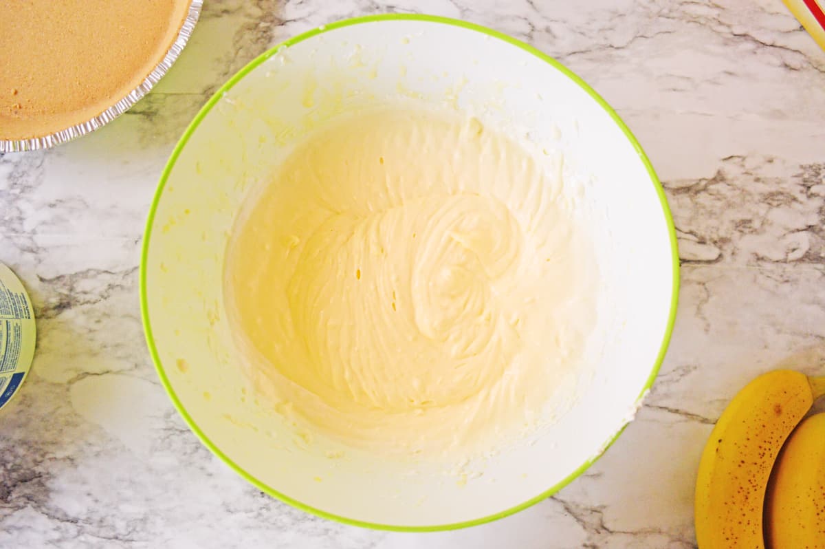 Banana pudding and cream cheese mixture in mixing bowl.