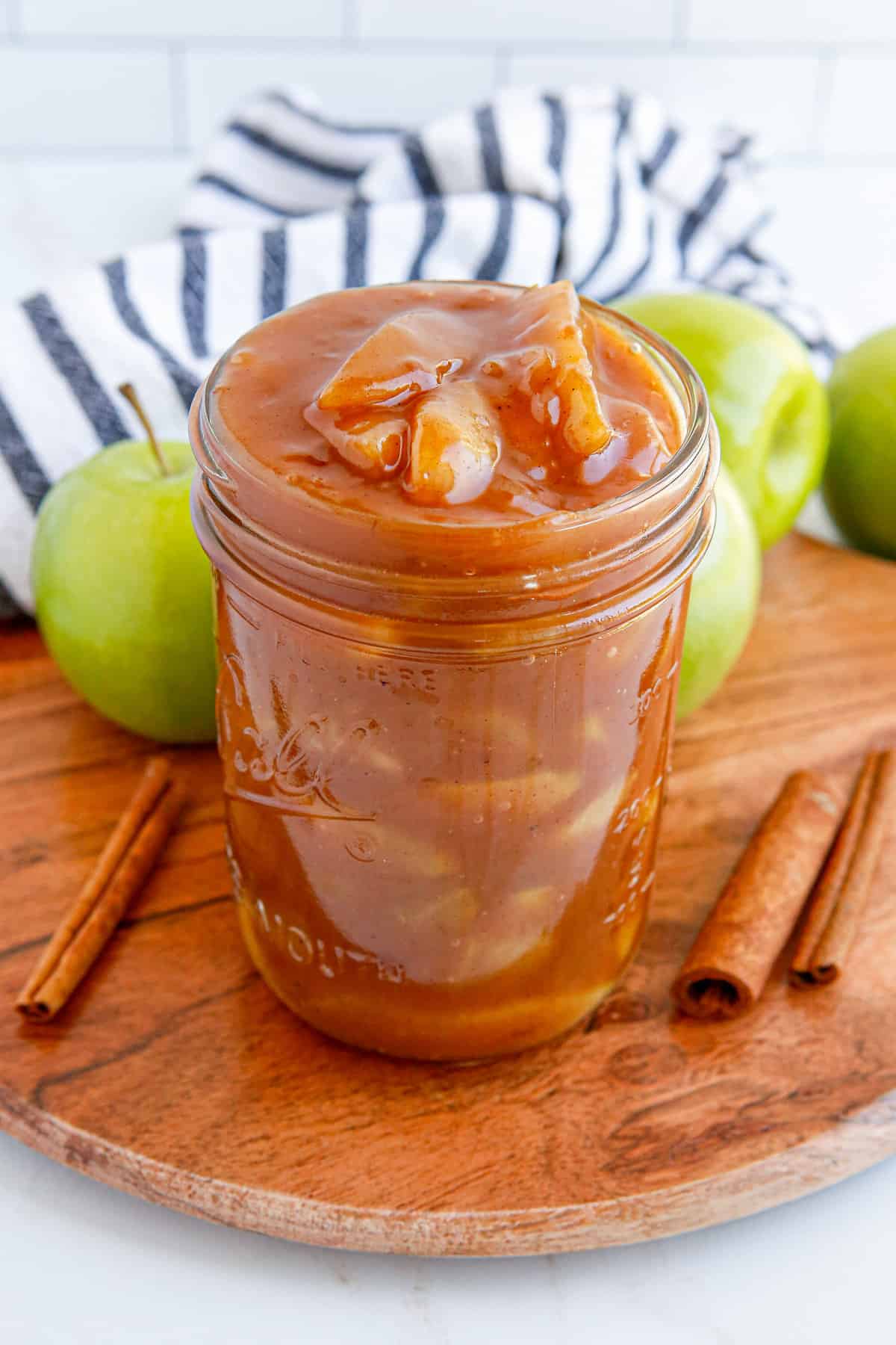 Homemade apple pie filling in mason jar without lid.