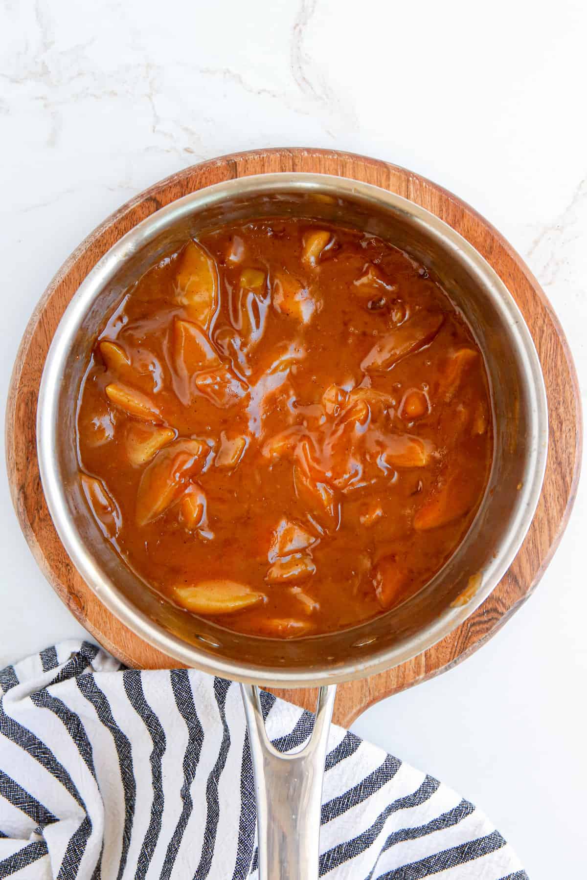 Homemade apple pie filling in pot.