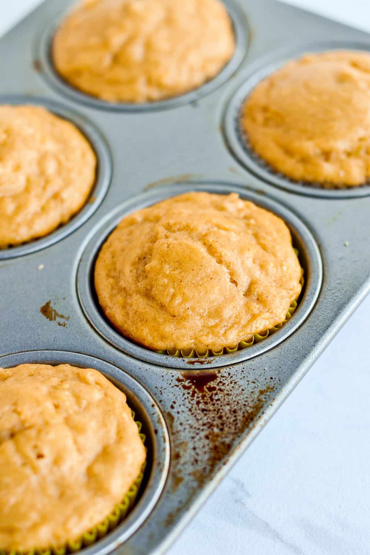 Apple spice muffins in muffin tin.