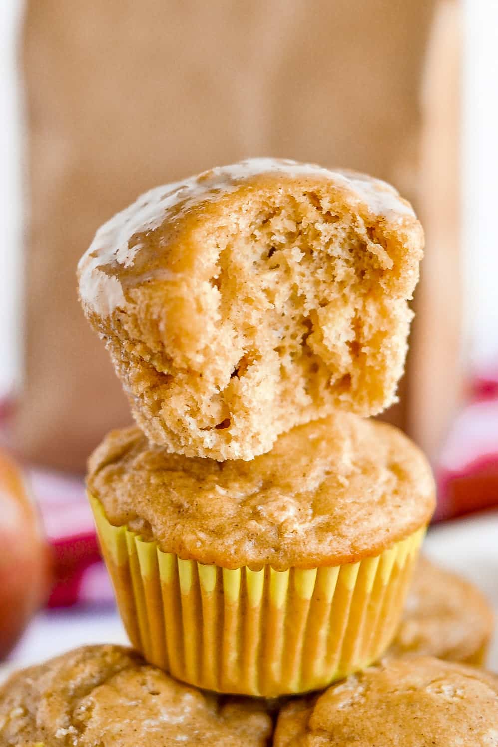 Apple muffin with bite taken out to show moist, tender crumb.