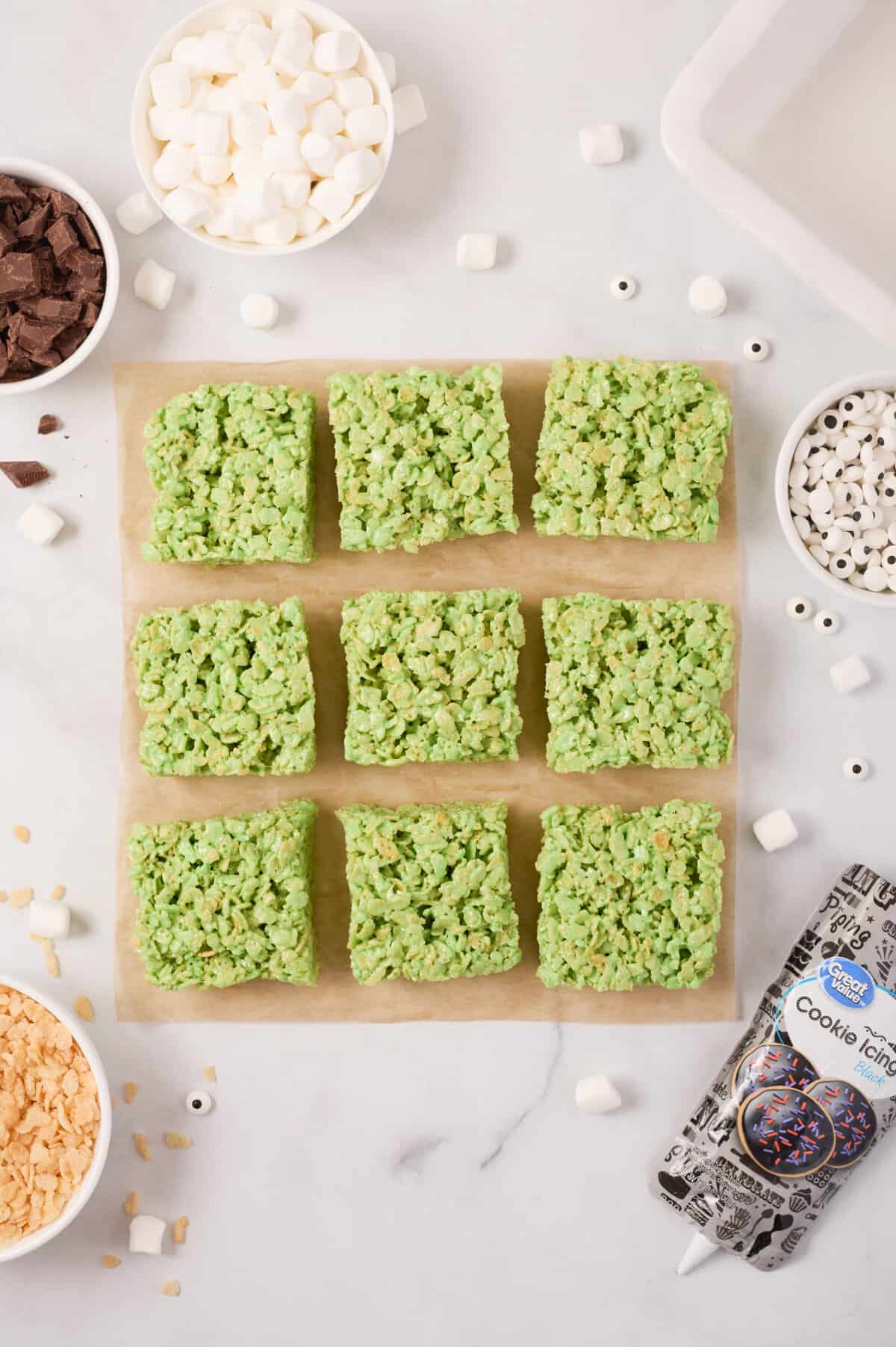 Green rice cereal treats cut into 9 equal squares.