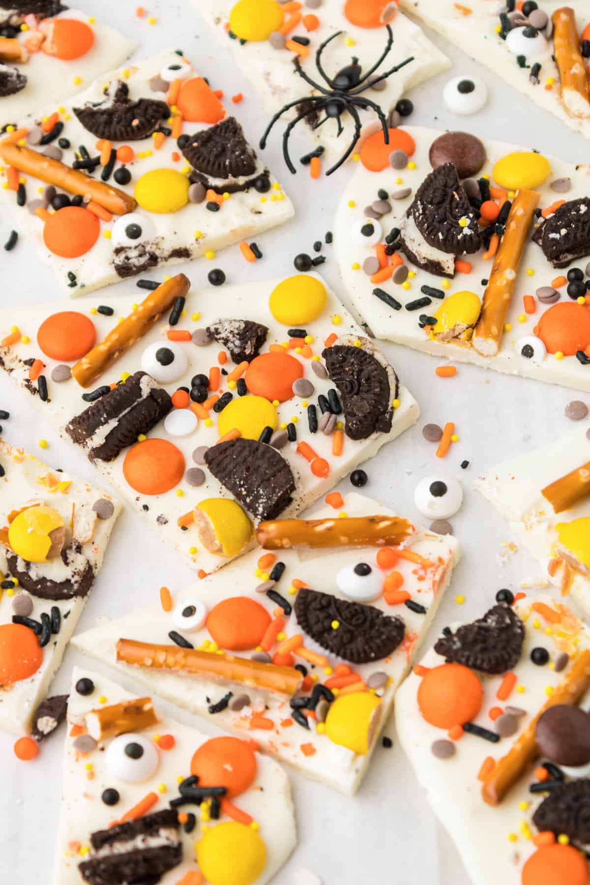Pieces of sweet and salty halloween bark on white background.