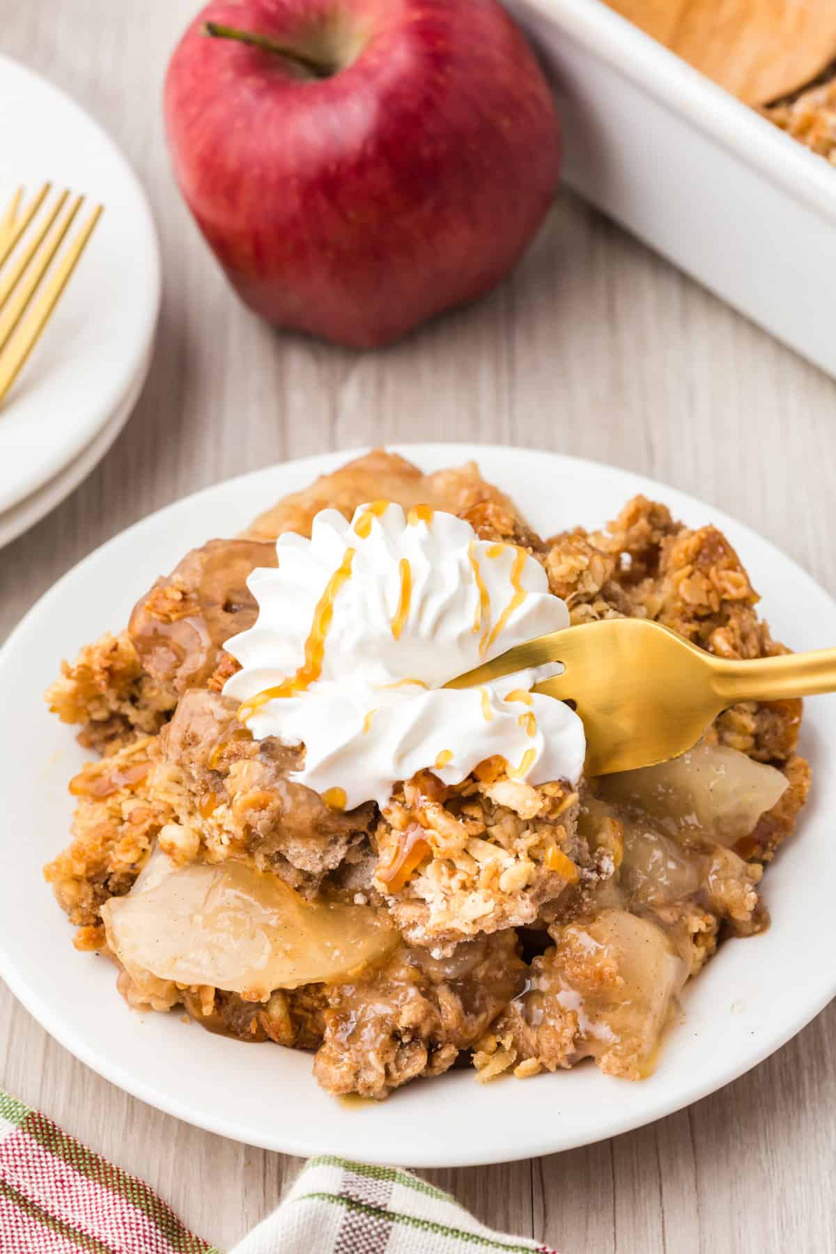 Form digging into a piece of apple crisp off plate.