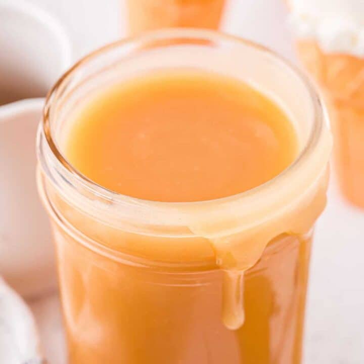 Homemade caramel sauce in a wide mouth mason jar.