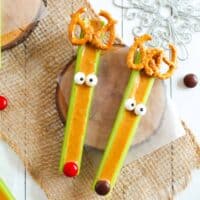 Celery reindeer decorated with pretzels, candy eyes, and M&Ms.