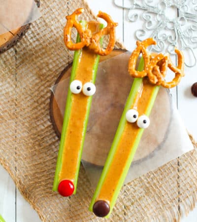 Celery reindeer decorated with pretzels, candy eyes, and M&Ms.