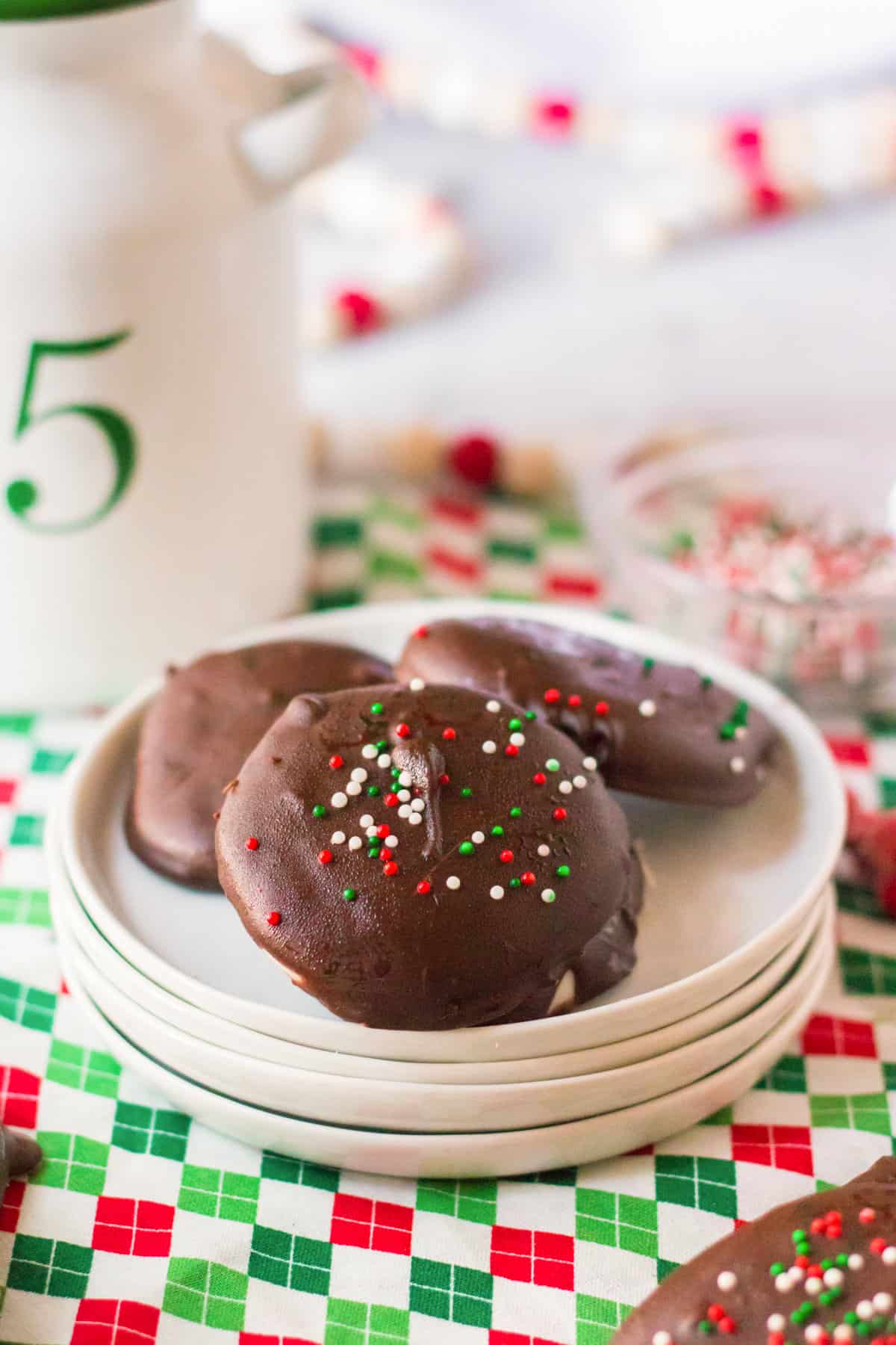 Homemade peppermint patties with red, green, and white sprinkles.