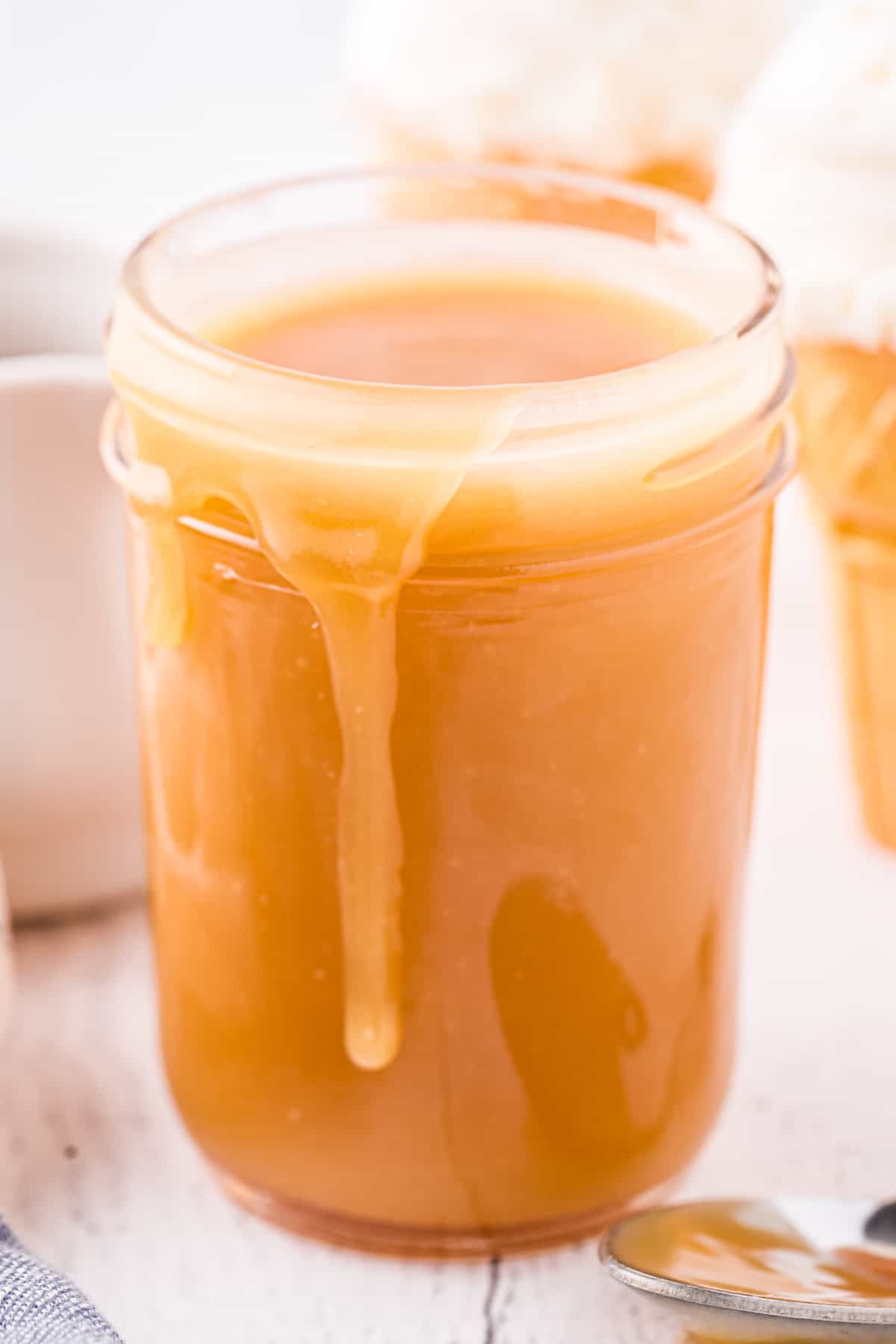 Wide mouth mason jar full of homemade caramel sauce.
