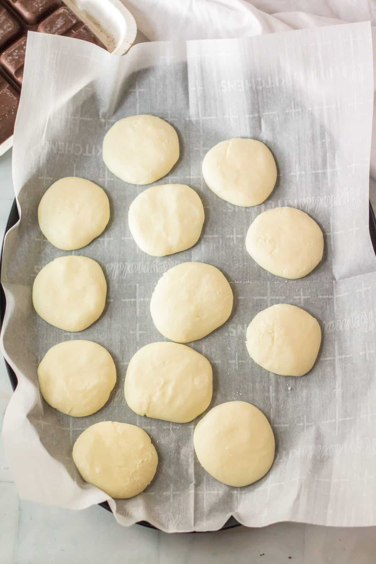 Pappermint patty filling shaped into discs and placed on lined pan.