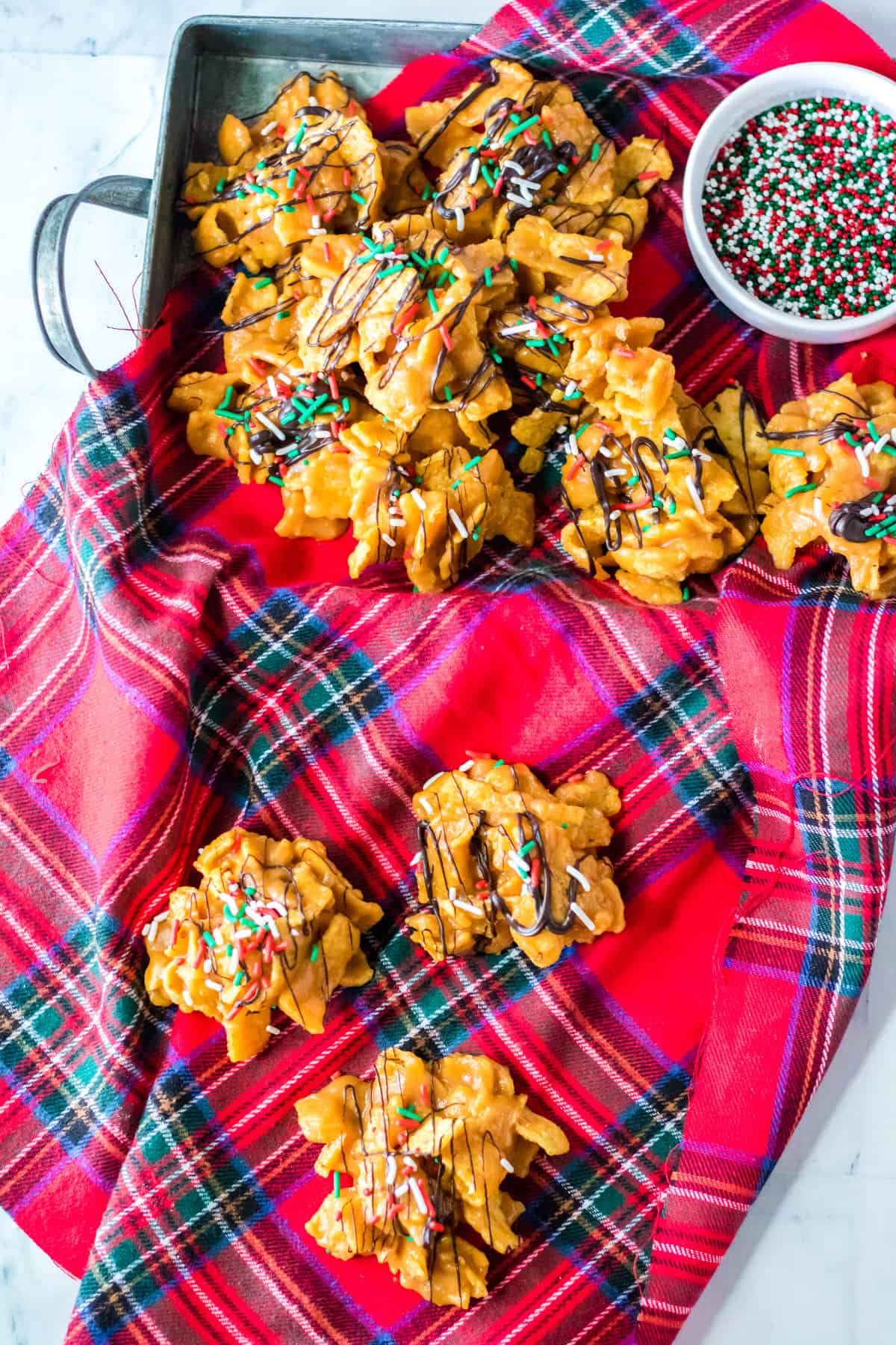 Peanut Butter fritos candies with holiday sprinkles on holiday napkin.