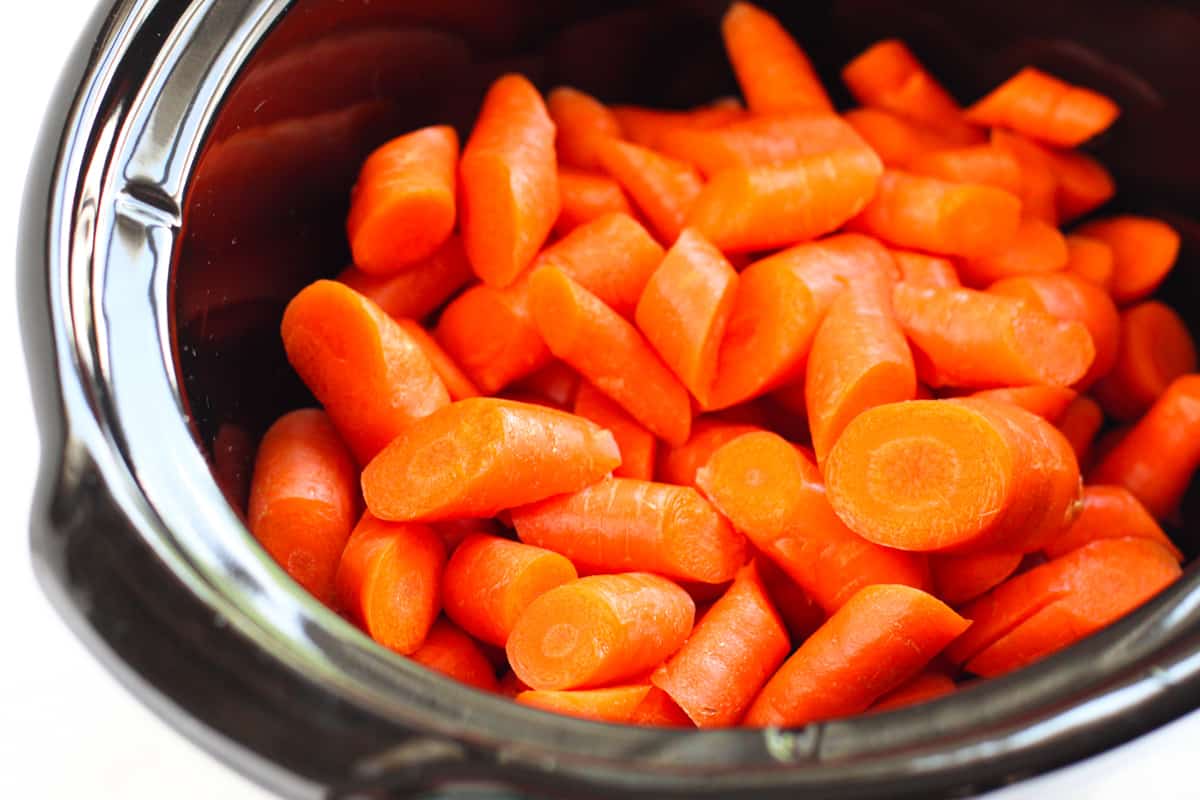 Raw chopped carrots in crockpot.