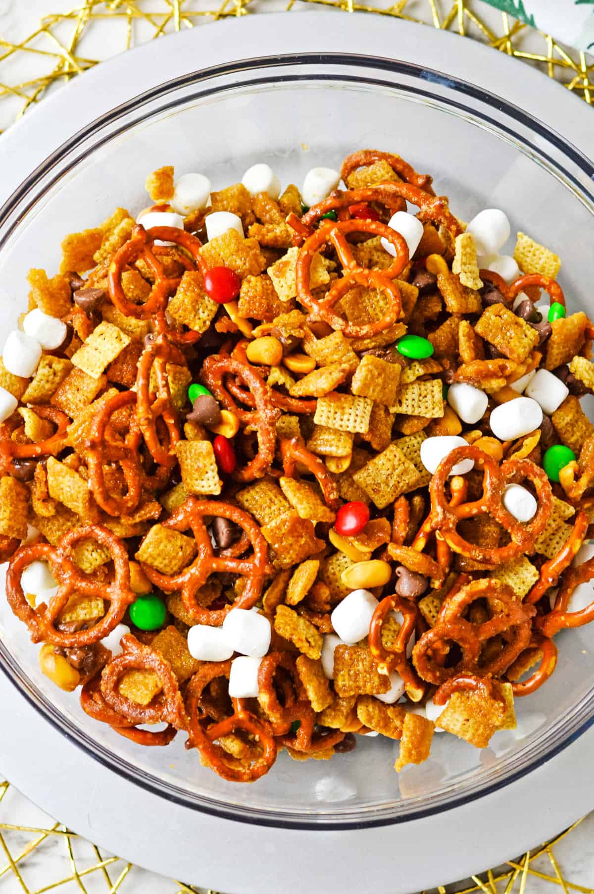 Christmas Chex mix with M&Ms and marshmallows in large mixing bowl.