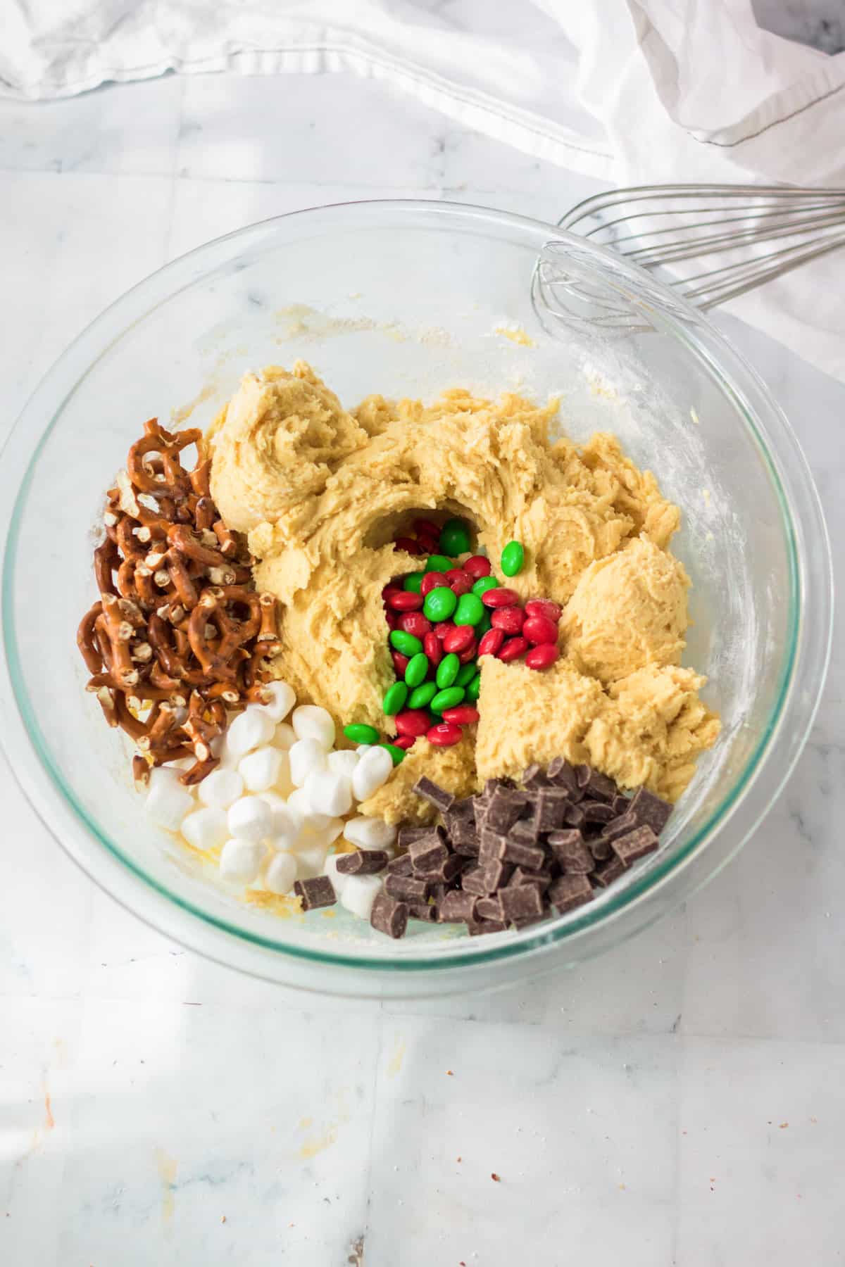 Cookie dough in bowl with mix-ins added.