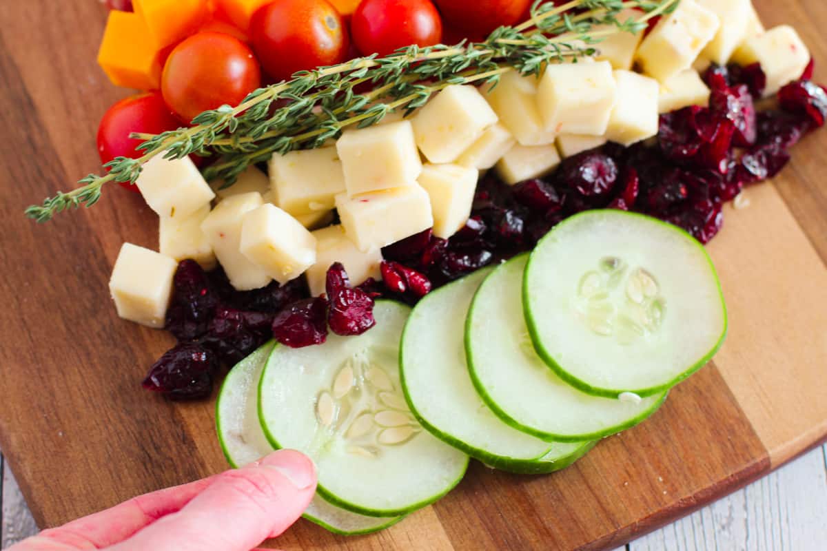 Placing slices of cucumbers on board.