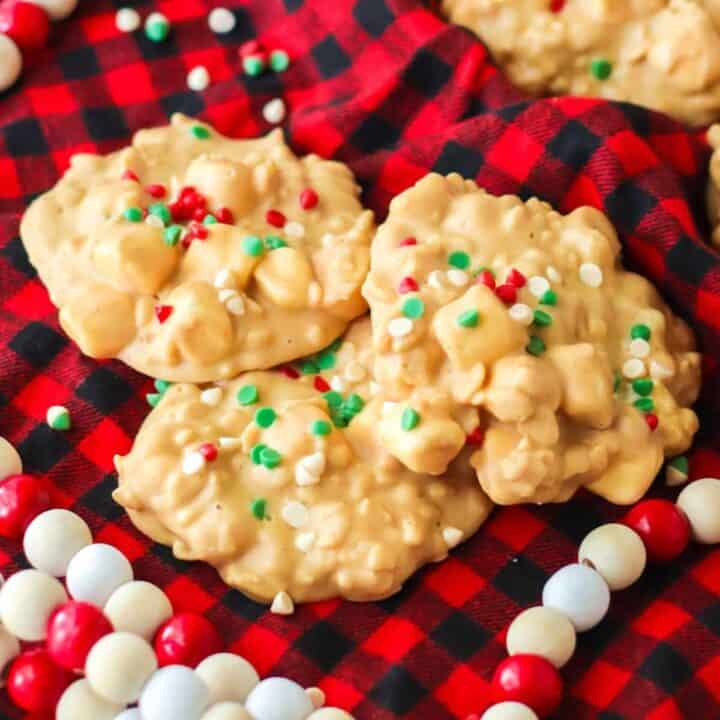 Crockpot avalanche cookies with red and green sprinkles on Christmas linen.