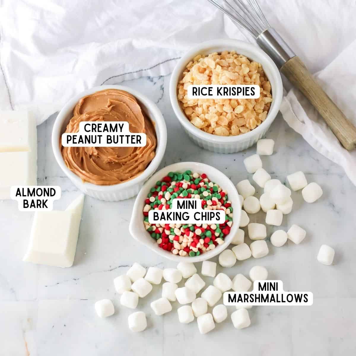 Ingredients for no bake slow cooker avalanche cookies: mini marshmallows, creamy peanut butter, almond bark, rice cereal, holiday mini chips.