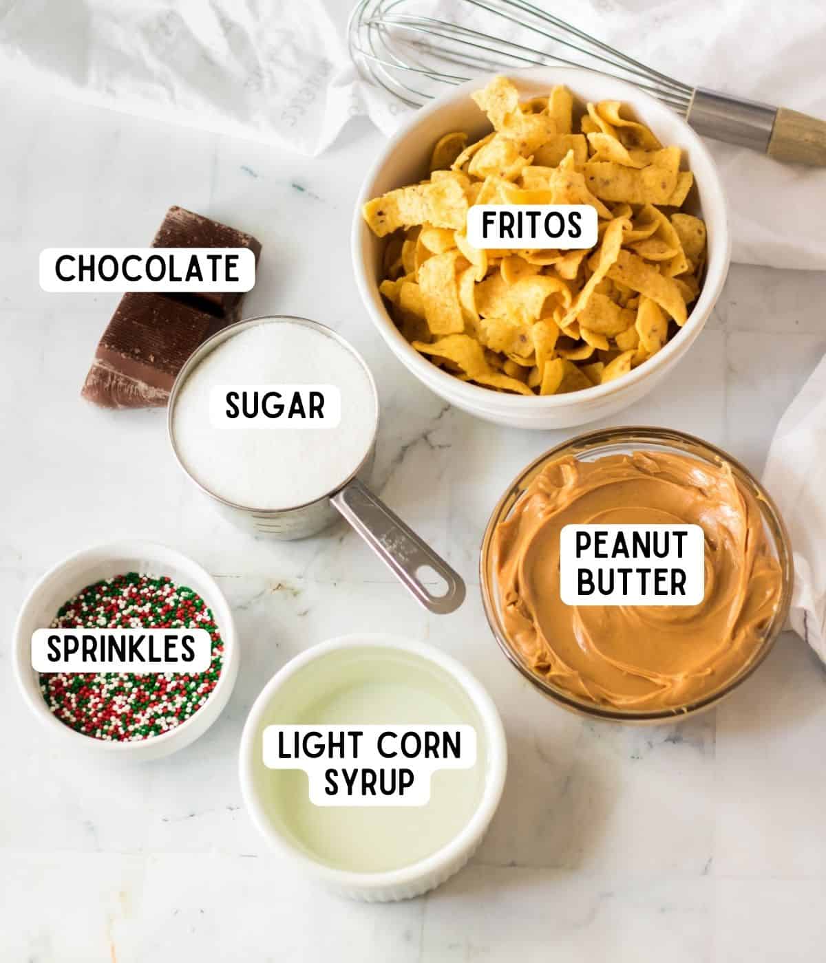 Fritos candy ingredients: chocolate almond bark, fritos, sugar, peanut butter, light corn syrup, and sprinkles.