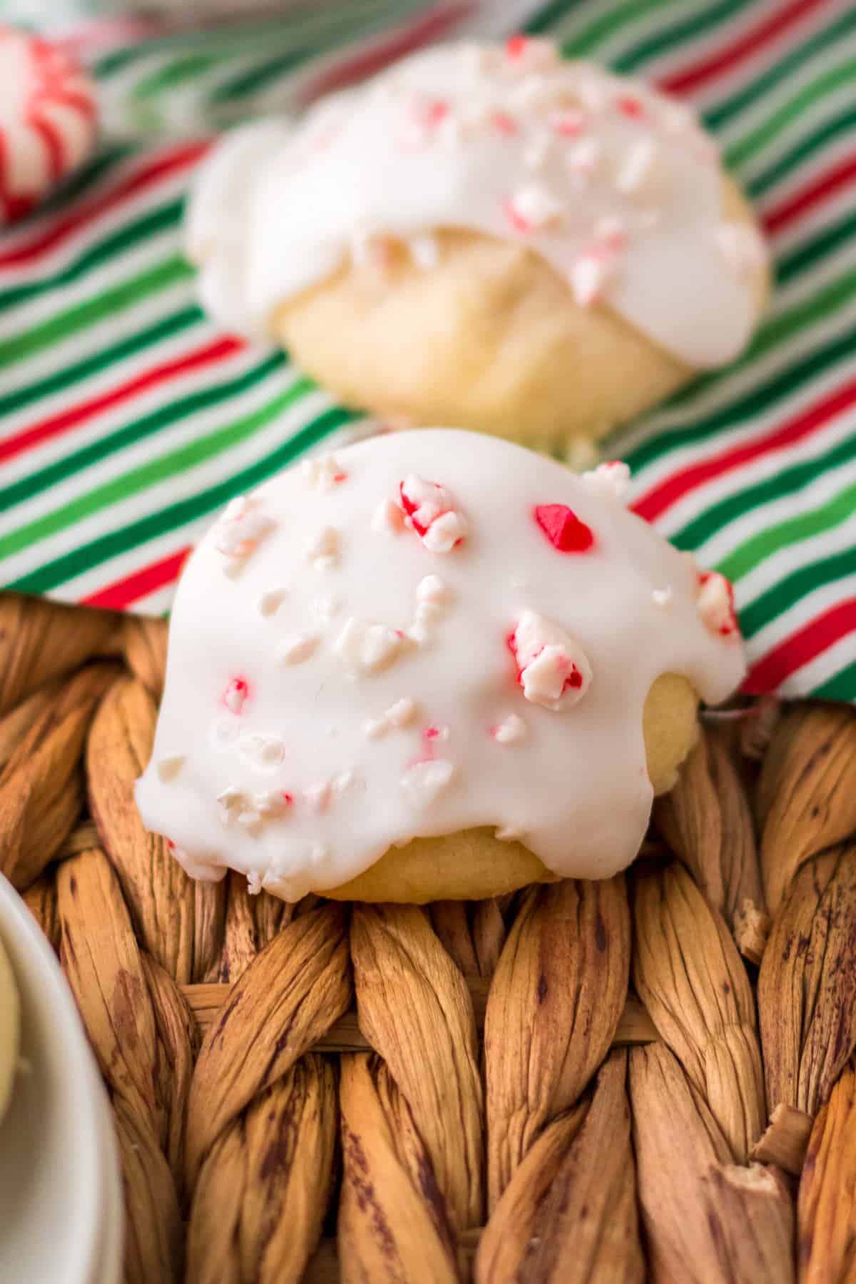 Close up of iced peppermint cookies on holiday napkin.