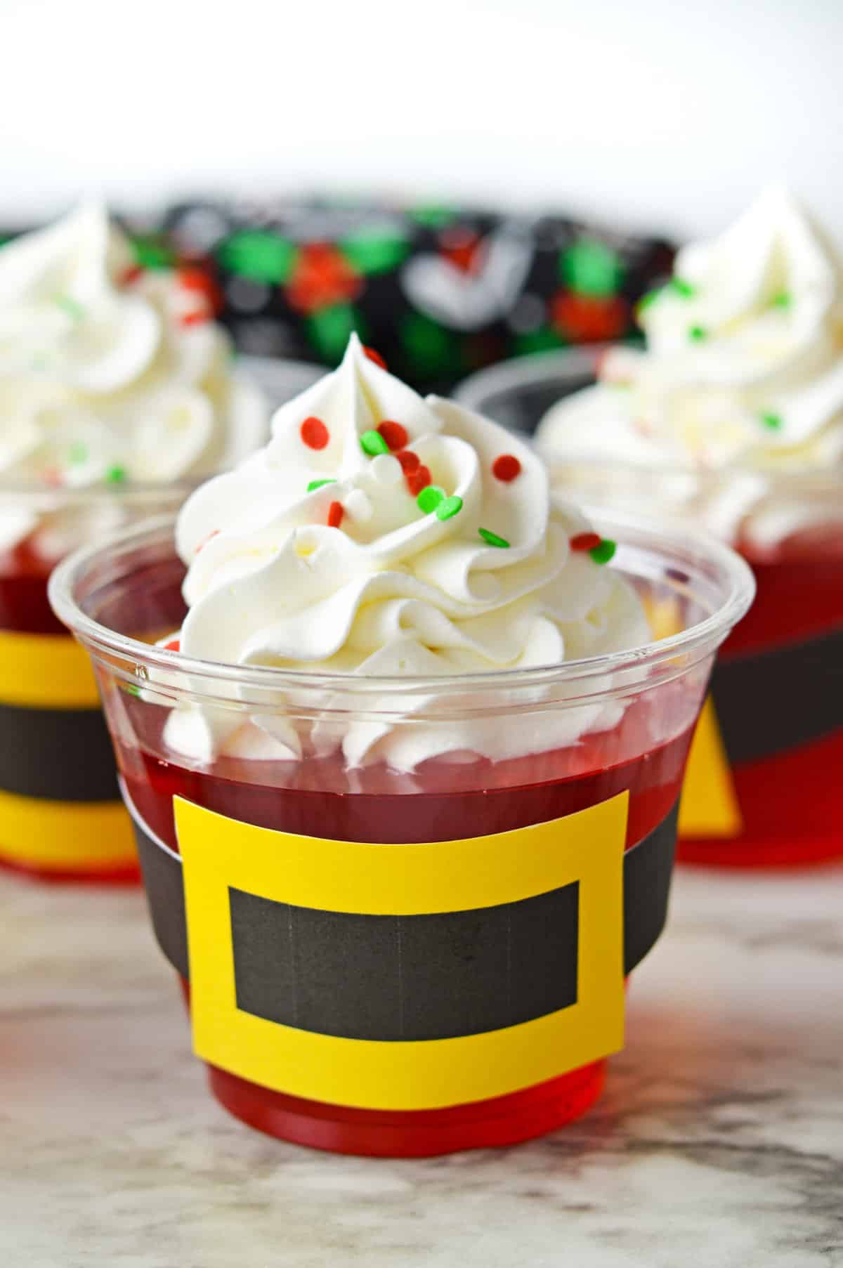 Santa Jello cups with Santa belt printable cut out and taped around the cups.