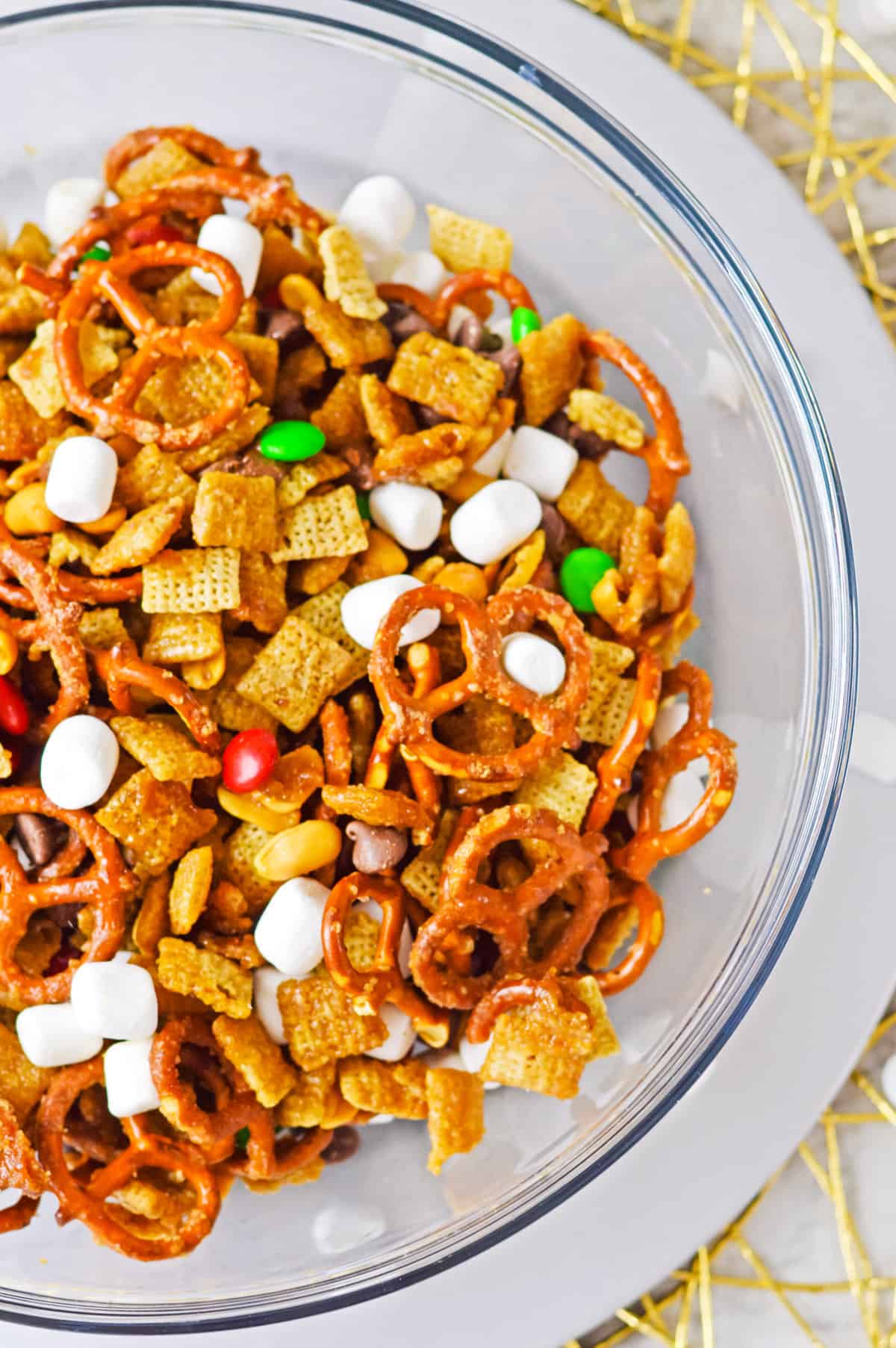 Overhead photo of holiday chex mix in glass bowl.