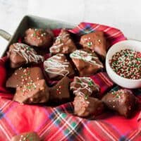Honeycomb candy coated in chocolate and topped with white chocolate drizzle and Christmas sprinkles.