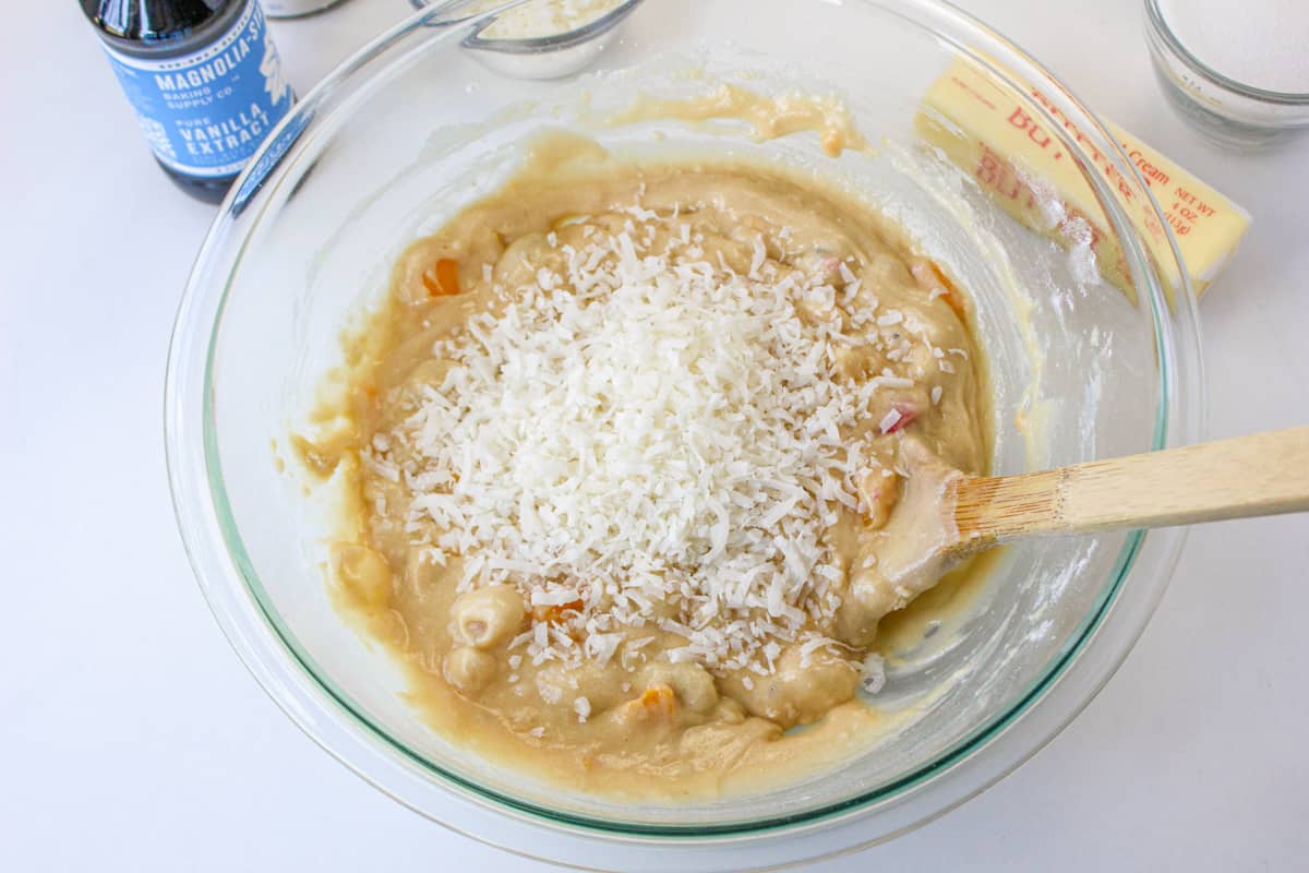 Shredded coconut added to mixing bowl.