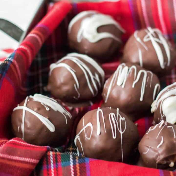 Martha Washington candy--chocolate coated coconut-pecan-cherry-candies--drizzled with white chocolate in a christmas tin.
