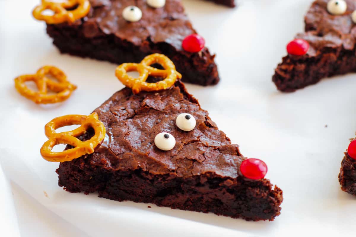 Triangular chocolate brownie decorated to look like Rudolph.