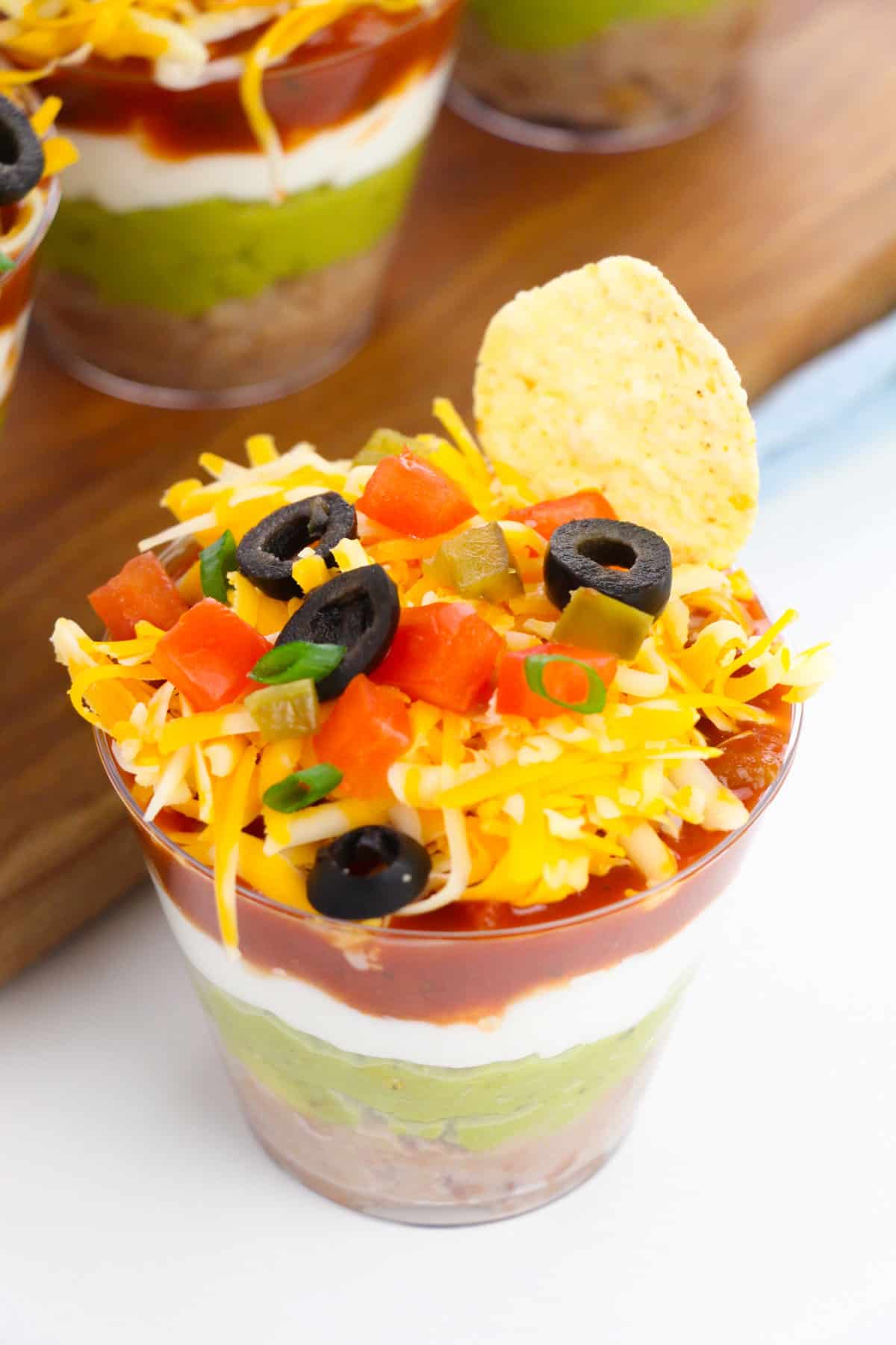 Taco dip cup with tortilla chip sticking out of the top.